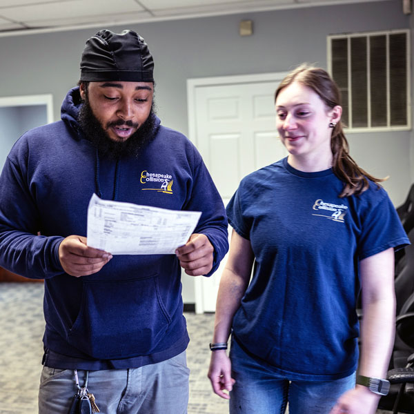 Lacy reviewing paperwork with her colleague at Chesapeake Collision